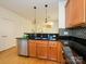 Well-lit kitchen features stainless steel appliances, granite counters and is open to the living area at 541 Jetton St, Davidson, NC 28036
