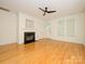 Bright living room featuring hardwood floors, fireplace, and natural light from large windows at 541 Jetton St, Davidson, NC 28036