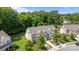 An aerial view showcasing the home's architectural design and its setting amongst mature trees and manicured lawns at 5621 Tipperlinn Way, Charlotte, NC 28278
