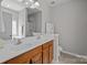 Well-lit bathroom featuring a double sink vanity, large mirror, and neutral finishes at 5621 Tipperlinn Way, Charlotte, NC 28278