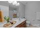 Bright bathroom showcasing a spacious countertop, modern fixtures, and a shower with a colorful curtain at 5621 Tipperlinn Way, Charlotte, NC 28278