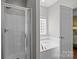 Bright bathroom with a separate glass shower and a soaking tub at 5621 Tipperlinn Way, Charlotte, NC 28278
