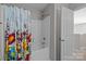 Bathroom shower with colorful patterned curtain and white tiled tub at 5621 Tipperlinn Way, Charlotte, NC 28278