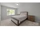 Bedroom featuring a cozy bed, neutral color palette, and ample natural light from the window at 5621 Tipperlinn Way, Charlotte, NC 28278