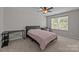 Comfortable bedroom with carpet, desk, and a window providing natural light at 5621 Tipperlinn Way, Charlotte, NC 28278