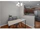 Bright dining area with hardwood floors, modern lighting, and open to the kitchen at 5621 Tipperlinn Way, Charlotte, NC 28278