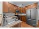 Modern kitchen with stainless steel appliances, wooden cabinetry, and granite countertops at 5621 Tipperlinn Way, Charlotte, NC 28278