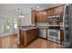 Updated kitchen with stainless steel appliances, wooden cabinetry, and breakfast bar at 5621 Tipperlinn Way, Charlotte, NC 28278