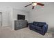 Upstairs sitting area with cozy sofa and entertainment stand with tv at 5621 Tipperlinn Way, Charlotte, NC 28278