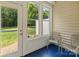 Cozy sunroom with blue floors, paneled walls, lots of light, and outdoor views at 5621 Tipperlinn Way, Charlotte, NC 28278
