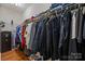 Organized walk-in closet with shelves and hanging rods for ample storage space at 5621 Tipperlinn Way, Charlotte, NC 28278
