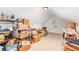Unfinished attic space with carpeted floors, window, and cluttered with boxes at 5706 Sustar Dr, Monroe, NC 28110