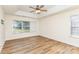 Spacious bedroom with a tray ceiling, hardwood floors, and natural light streaming in from the window at 5706 Sustar Dr, Monroe, NC 28110