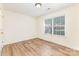 This bedroom offers lots of light from its large window, and features hardwood style flooring at 5706 Sustar Dr, Monroe, NC 28110