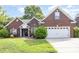 Charming brick home featuring a two-car garage and well-maintained lawn at 5706 Sustar Dr, Monroe, NC 28110