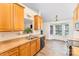 Functional kitchen with wooden cabinets, stainless steel appliances, and an adjacent breakfast nook area at 5706 Sustar Dr, Monroe, NC 28110