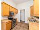 Modern kitchen with stainless steel appliances, wooden cabinets, and hardwood flooring for easy cleaning at 5706 Sustar Dr, Monroe, NC 28110