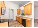 Modern kitchen with stainless steel appliances, wooden cabinets, and hardwood flooring for easy cleaning at 5706 Sustar Dr, Monroe, NC 28110
