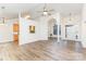 Open-concept living room with arched doorways, hardwood floors, and ample natural light at 5706 Sustar Dr, Monroe, NC 28110