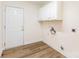 Utility room with vinyl flooring and storage cabinets and utility hookups at 5706 Sustar Dr, Monroe, NC 28110