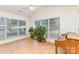 Light filled sunroom with large windows and tile flooring, offering a relaxing space for plants and a piano at 5706 Sustar Dr, Monroe, NC 28110