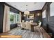 Elegant dining room featuring dark accent wall, modern chandelier, and large window at 6308 Honor Ave, Midland, NC 28107