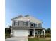 Charming two-story home with gray siding, white trim, and a two-car garage at 6308 Honor Ave, Midland, NC 28107