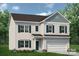 Charming two-story home with a well-manicured lawn and an attached two-car garage at 6308 Honor Ave, Midland, NC 28107