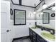 A stylish bathroom with black and white accents, custom lighting, and olive-green sinks at 70 Cumberland Sw Ct, Concord, NC 28025