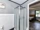 A bathroom with a glass shower and dark flooring leading into a bedroom at 70 Cumberland Sw Ct, Concord, NC 28025