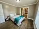 This bedroom features wood-look flooring and a connecting door to the living area at 70 Cumberland Sw Ct, Concord, NC 28025