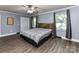 A bedroom featuring wood floors, and a plaid bed with wooden headboard at 70 Cumberland Sw Ct, Concord, NC 28025