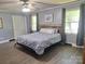 Charming bedroom with wood-look floors, calming wall color, and large windows at 70 Cumberland Sw Ct, Concord, NC 28025