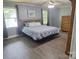 Relaxing primary bedroom with natural light, wood floors, and calming wall color at 70 Cumberland Sw Ct, Concord, NC 28025