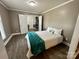 Cozy bedroom featuring hardwood floors, neutral paint, and a comfortable-looking bed with decorative pillows at 70 Cumberland Sw Ct, Concord, NC 28025