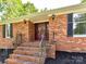 Close-up of the front entrance with brick steps and a decorative front door at 70 Cumberland Sw Ct, Concord, NC 28025