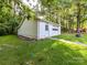 A one-car garage with white siding and a garage door, plus a standard entry door at 70 Cumberland Sw Ct, Concord, NC 28025