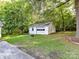 Detached garage on a grassy lawn, surrounded by mature trees, with driveway access at 70 Cumberland Sw Ct, Concord, NC 28025