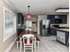 An eat-in kitchen with dark cabinetry, stainless steel appliances, and a window over the sink at 70 Cumberland Sw Ct, Concord, NC 28025