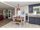 An eat-in kitchen with wood-look flooring, dark cabinetry, and a table with bench seating at 70 Cumberland Sw Ct, Concord, NC 28025