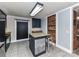 A kitchen area featuring a prep island, upper and lower cabinetry, and brick accents at 70 Cumberland Sw Ct, Concord, NC 28025