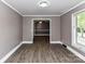 An open living room area with wood-look flooring and neutral-colored walls and trim at 70 Cumberland Sw Ct, Concord, NC 28025