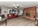 Spacious living room featuring a brick fireplace and wood-look flooring at 70 Cumberland Sw Ct, Concord, NC 28025