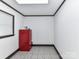 A bonus space with white walls and tile flooring offers a versatile area for storage at 70 Cumberland Sw Ct, Concord, NC 28025