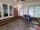 Bright sun room with durable flooring, multiple windows, and brick accents for a cozy ambiance at 70 Cumberland Sw Ct, Concord, NC 28025