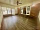 Inviting sunroom with brick accents, wood floors, and plenty of natural light, creating a cozy atmosphere at 70 Cumberland Sw Ct, Concord, NC 28025