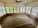 Bright sunroom with wood floors, brick accents, and multiple windows offering ample natural light and a pleasant view at 70 Cumberland Sw Ct, Concord, NC 28025