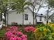Back exterior view shows brick siding with beautiful flowers and landscaping at 713 Sloop Ave, Kannapolis, NC 28083