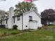 Back exterior view with a brick chimney and back screened-in porch at 713 Sloop Ave, Kannapolis, NC 28083