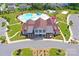 Stunning aerial shot of the community center featuring a large pool, playground, and meticulously landscaped grounds at 7332 Newsome Sw Ct, Concord, NC 28025